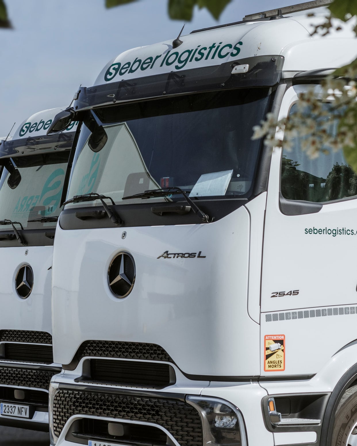 Row of Seber Logístics Euro VI trucks parked at the base